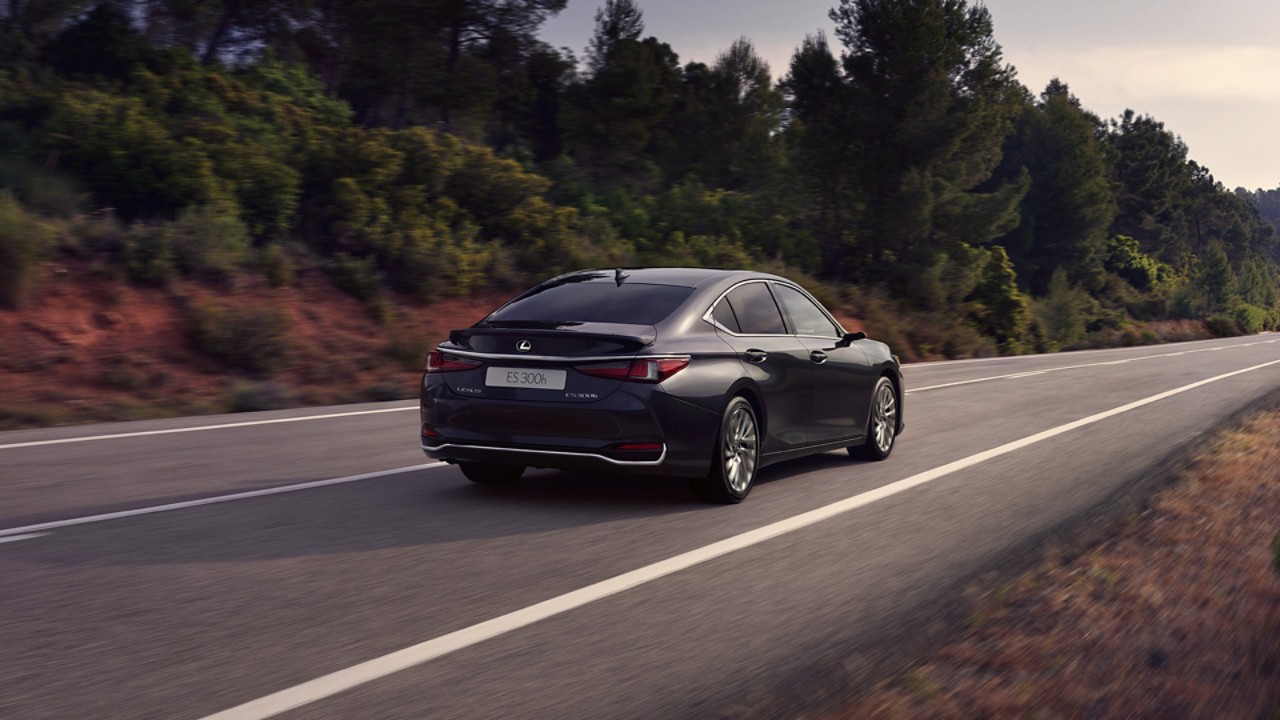 A black Lexus ES 300h driving on a road