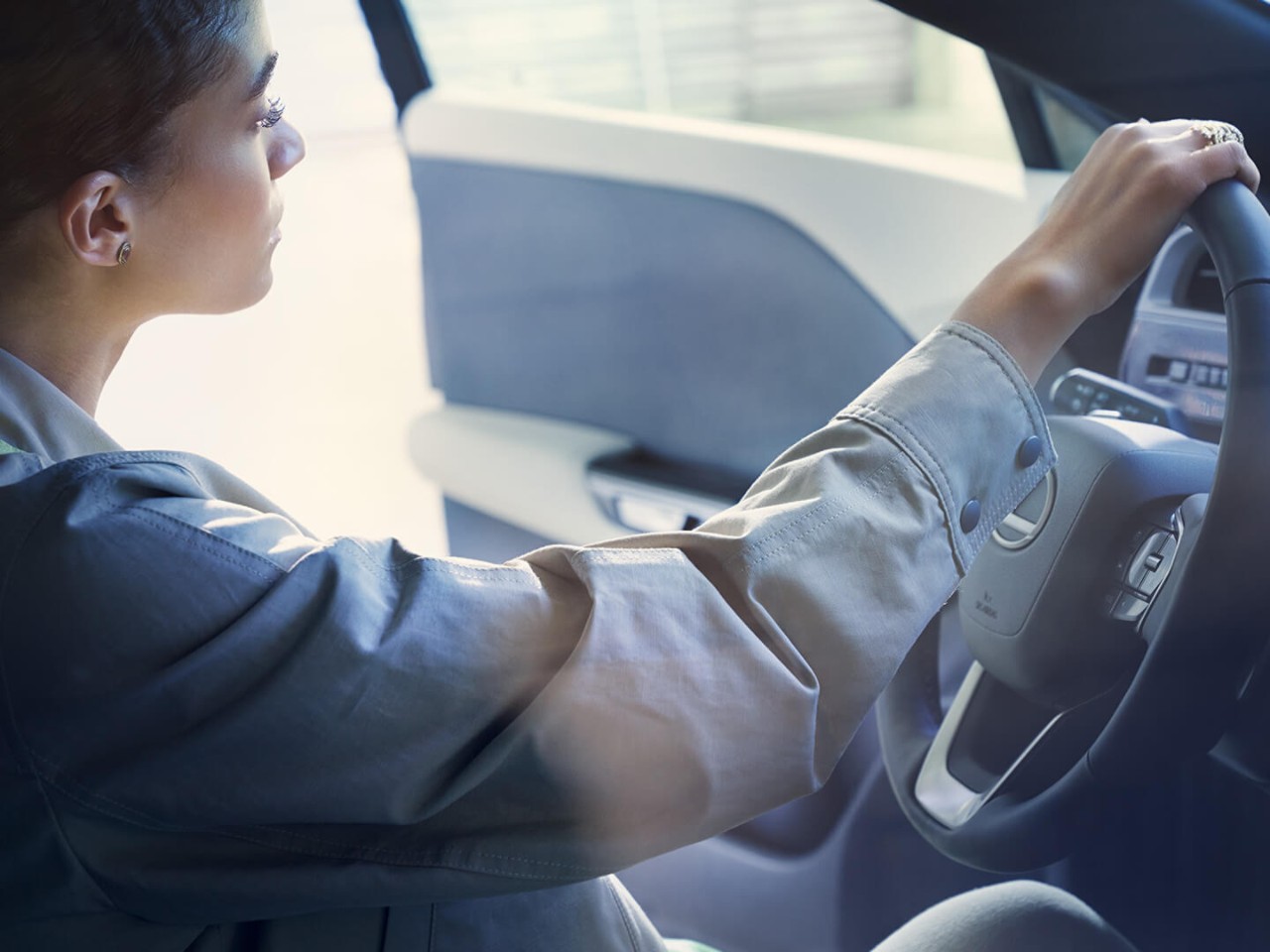 A woman sat in a Lexus RZ