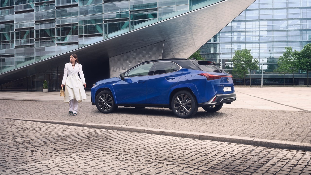 A person walking away from a Lexus UX 300h